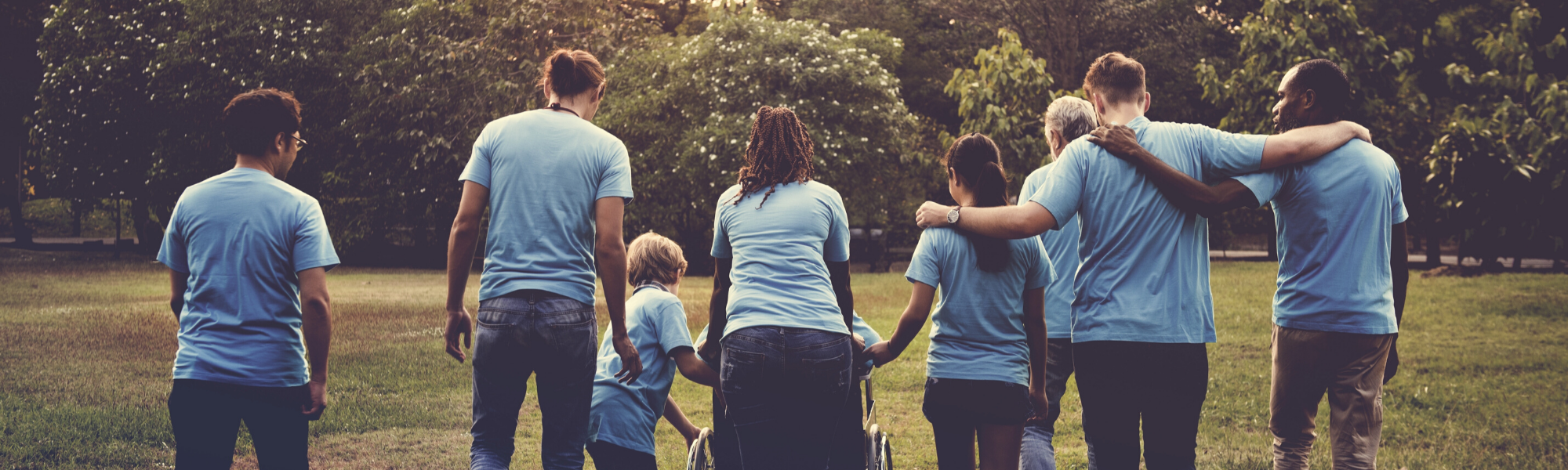 Group of adults and children walking in a park. Find your local nursing agency. Care jobs near you. 