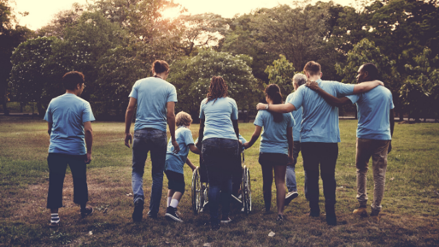 Group of adults and children walking in a park. Find your local nursing agency. Care jobs near you. 